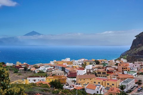 The village of Agulo, behind Tenerife and the Teide in clouds, Agulo, La Gomera, Canary Islands,