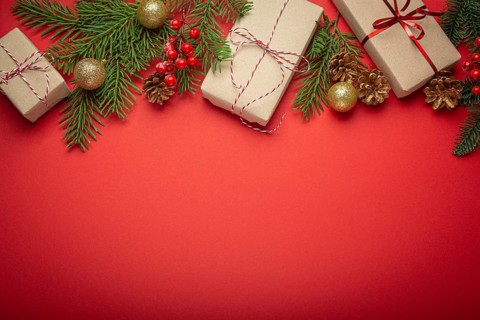 Christmas or New Year celebration red paper festive background with decoration fir tree, wrapped