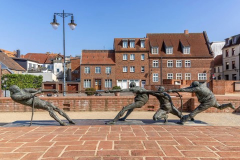 Walled-up ground plan of the former St Mary's Church and sculpture Tug of War - The Strongest by