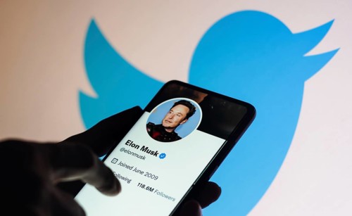 In this photo illustration, the Elon Musk Twitter account displayed on a smartphone screen and
