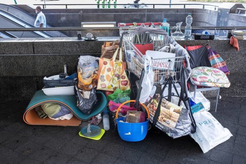 Hanover - Poverty, homelessness. Belongings in plastic bags and a shopping trolley on the stairs to