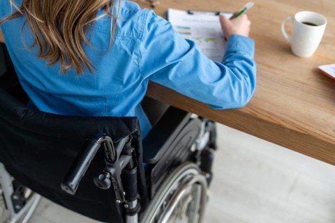 Close up woman wheelchair working office