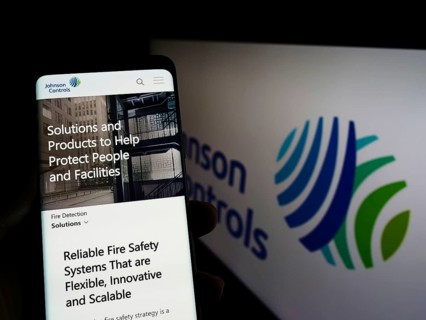 Stuttgart, Germany, 03-12-2022: Person holding cellphone with webpage of company Johnson Controls