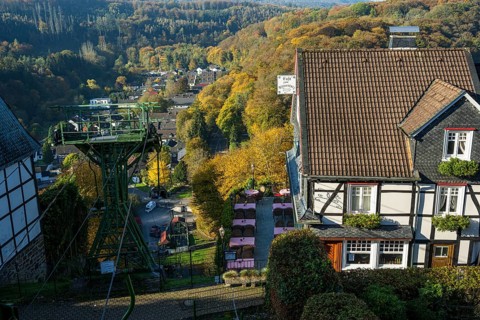 Autumn landscape with a view of a cable car and traditional village architecture, Burg Castle in