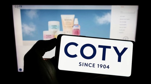 Stuttgart, Germany, 10-03-2022: Person holding cellphone with logo of US beauty company Coty Inc.