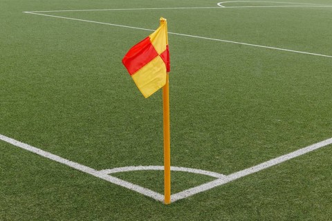 Corner of a ball soccer field wwith pile and flag