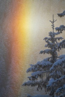 Winter rainbow with deep fresh snow at sunrise