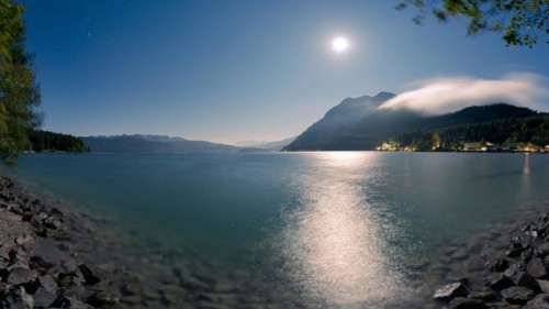 Mountain lake Walchensee with village Urfeld and Herzogstand in Bavaria, Germany at night with