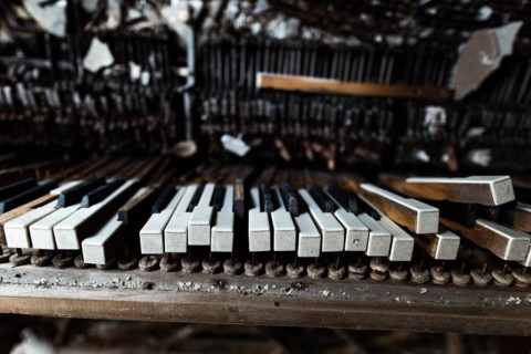 Detail of broken grand piano in mess hall of abandoned military base in Chernobyl Exclusion Zone of