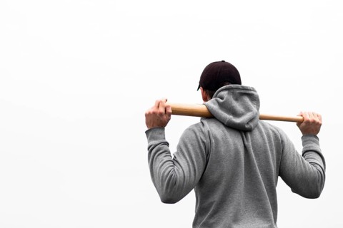 Back view man holding baseball bat shoulders