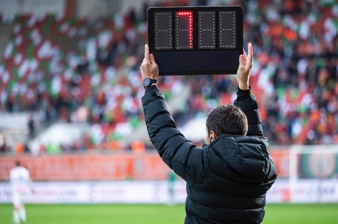 Technical referee shows added time during football match