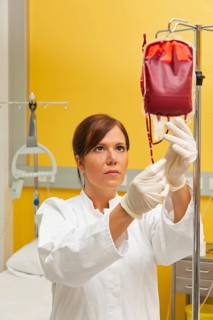 A nurse in hospital with blood bottle. Infusion of donor blood, A nurse in hospital with blood