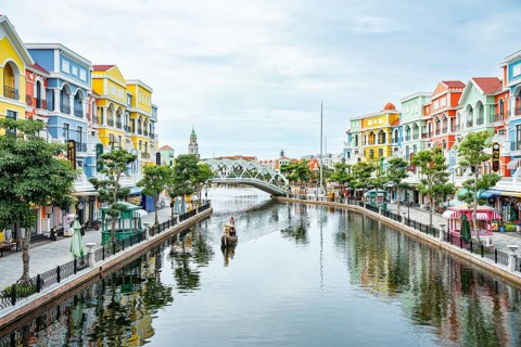 Vibrant buildings and a bridge reflected in a calm river under a clear sky, park, venice copy city,