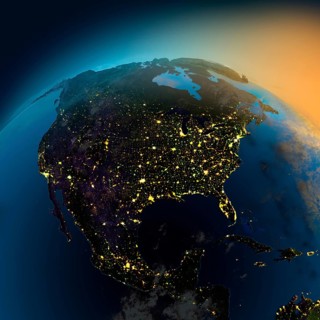 Night view of North America from the satellite to the glowing lights of towns on the sunrise from
