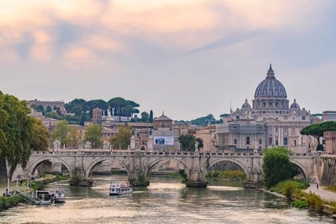 Sunset view of St. Peter's Basilica, Ponte Sant'Angelo, and Tiber River in Rome, Italy, Europe