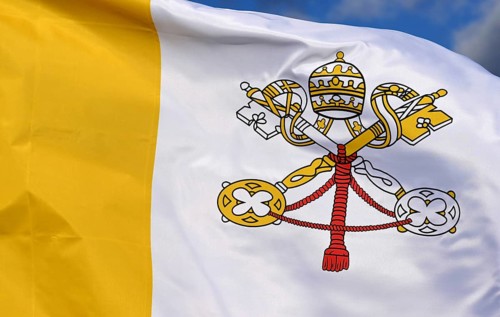 Close-up of the national flag of the Vatican State, fluttering in the wind with folds, wave