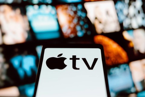 In this photo illustration, the Apple TV logo is displayed on a smartphone screen