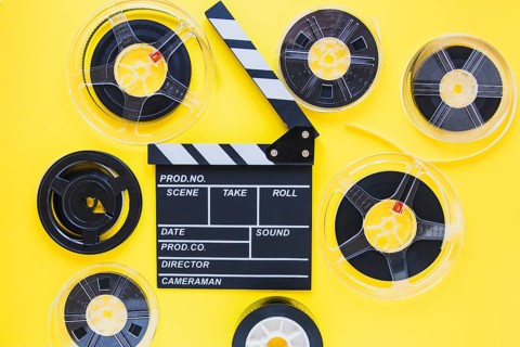 Arrangement film reels clapboard. Beautiful photo