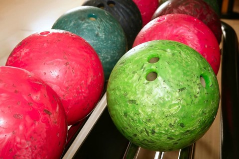 Bowling balls red green closeup row detail