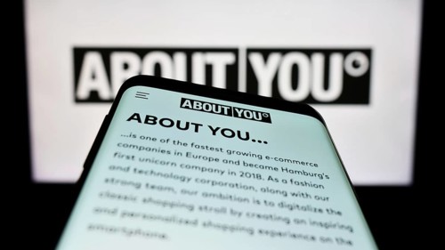 Stuttgart, Germany, 03-14-2023: Smartphone with webpage of German e-commerce company About You SE