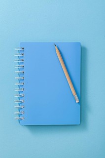 Blue Notepad With Wooden Pencil Close Up