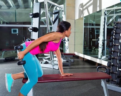 Dumbbell triceps kickback girl workout exercise at gym