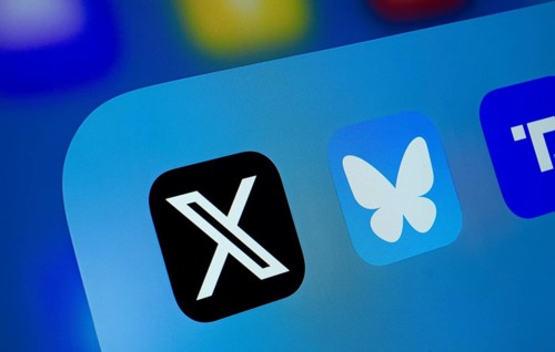 A close up of an iPad screen displaying the X, Bluesky and Truth Social app
