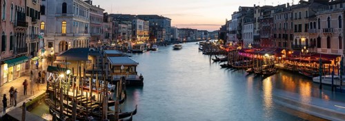 Evening light at sunset, view over the Grand Canal, gondola and boats, from the Rialto Bridge,