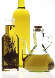 OLIVE OIL, BOTTLES AGAINST WHITE BACKGROUND