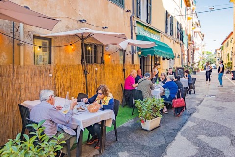 Guests at the tables in front of the restaurants in Via Roma, Orbetello, Tuscany