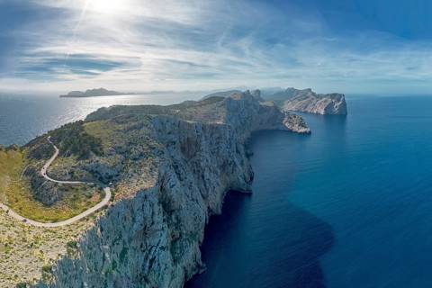 Aerial panorama landscape view of the curving road and rugged Cap de Formentor in northwestern