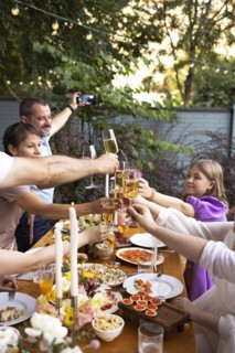 HAppy friends saying cheers and showing their champagne glasses full of sparkling wine to each