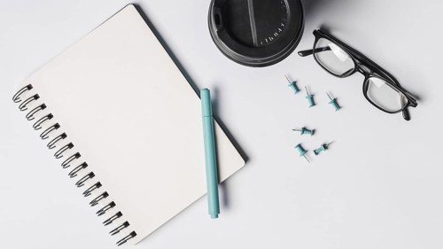 Blank spiral notepad pen coffee cup eyeglasses pushpins white background. Resolution and high