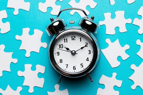 Retro alarm clock jigsaw puzzle pieces blue backdrop