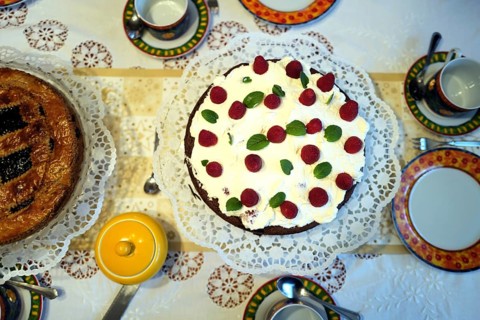 A raspberry cream cake beside a Linzer torte on a table before coffee and cake. Coburg, Germany,