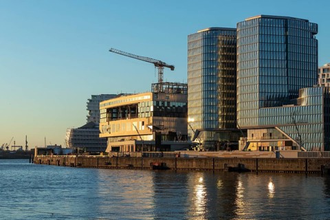 Modern architecture on the Elbe in the evening light on the promenade in Überseequartier,