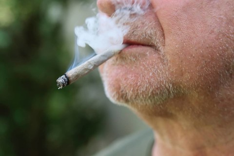A man smokes a joint
