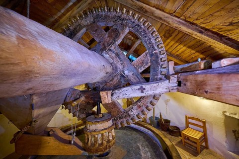 Interior view with wooden mill wheel in a rustic attic, Kefalos, Kos, Dodecanese, Greek Islands,