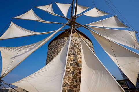 Wide sails on a stone windmill, blue sky in the background, windmill, Antimacheia, Kos, Dodecanese,
