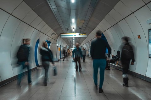 Tourists and commuters navigating an underground corridor in london, united kingdom, surrounded by