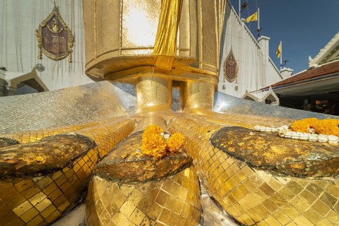 Feet of a 32 metre high standing Buddha decorated with glass mosaics and 24-carat gold, Luang Pho