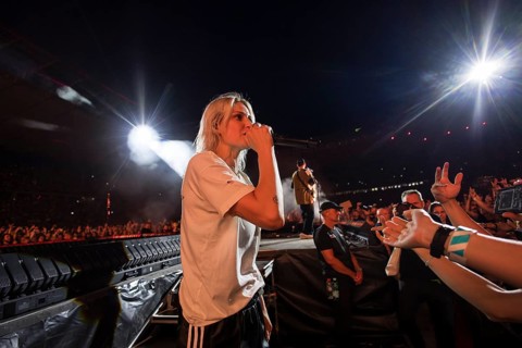 Emily Armstrong, lead singer of Linkin Park in the photo pit between the audience live on From Zero