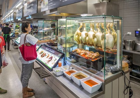 Thai woman ordering food in the cafeteria at the Big C Supercenter in Chiang Rai, Thailand, Asia