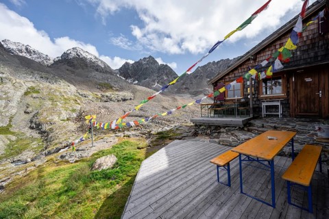 Colourful prayer flags, terrace at a mountain hut, mountain hut Adolf-Nossberger-Hütte, mountain