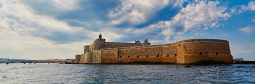 Castello Maniace, Maniace sea fortress, large Mediterranean fortress under a cloudy sky on the