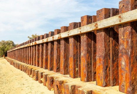 Old rusty steel sheet piling sea wall coastal defence, River Deben, Bawdsey, Suffolk, England, UK