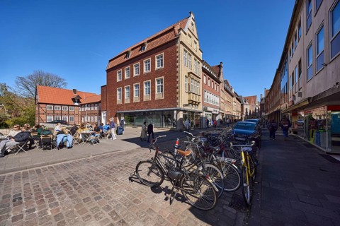 Old town, historic buildings, gables, bicycles, cobblestone street, outdoor area of a restaurant,