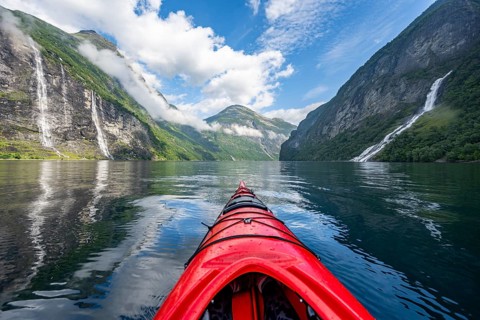 Kayak trip on the Geirangerfjord with waterfall The Seven Sisters and Freier Waterfall, tip of a