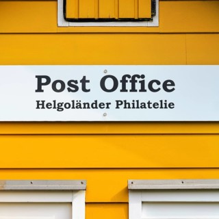 Yellow lobster shack, sign with inscription post office, Helgoland philately, facade detail, Museum