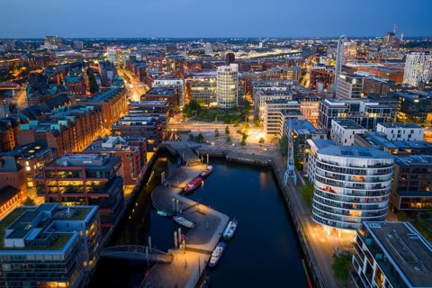 Aerial view of the Speicherstadt Hamburg with Magellan Terraces at Sandtor harbour at blue hour,